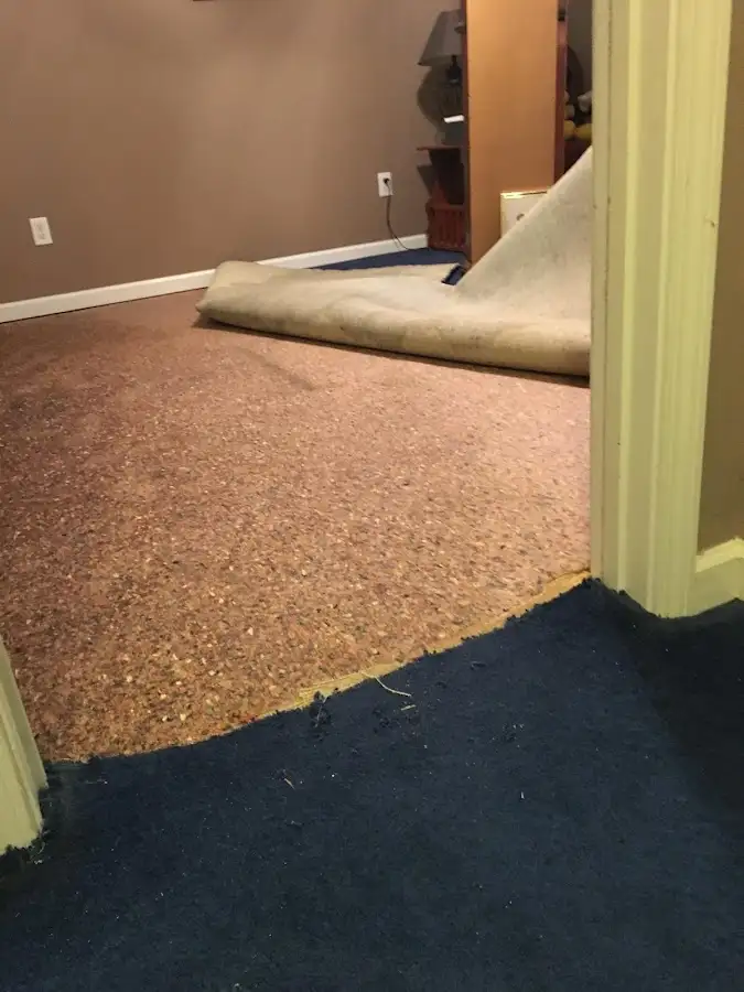 Carpet pad removal revealing water damage during Drying & Dehumidification in Estherville